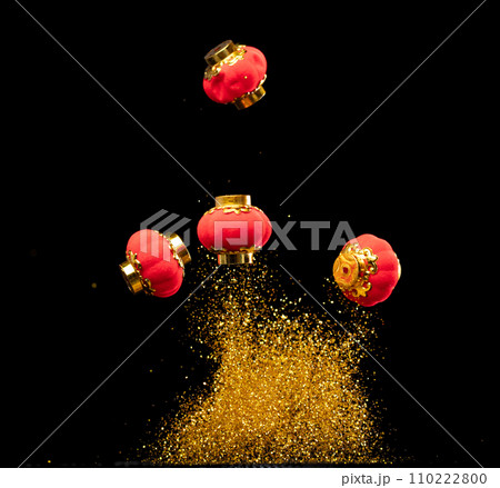 Gold Chinese Money lantern fly with dust particle in air. Chinese new year Yuanbao gold lantern floating to golden money sand particle. Language is wealthy prosperity. Black background isolated 110222800