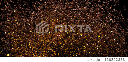 Ground Coffee roasted powder dust fly explosion, Coffee crushed ground float pouring. Roasted Coffee powder ground dust splash explosion in mid Air. Black background Isolated gold bokeh Ground Coffee roasted powder dust fly explosion, Coffee crushed ground float pouring. Roasted Coffee powder ground dust splash explosion in mid Air. Black background Isolated gold bokeh 110222828