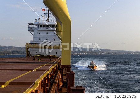 Pilot boat and cargo vessel at sea. Pilot embarkation. Pilotage. 110222875