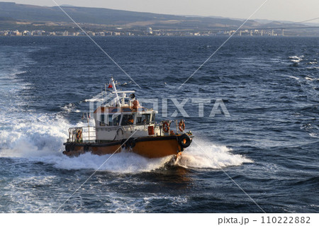 Pilot boat and cargo vessel at sea. Pilot embarkation. Pilotage. 110222882