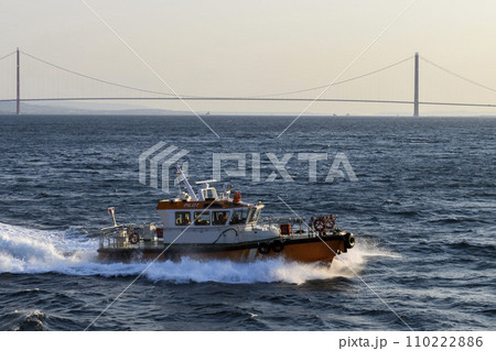 Pilot boat and cargo vessel at sea. Pilot embarkation. Pilotage. Pilot boat and cargo vessel at sea. Pilot embarkation. Pilotage. 110222886