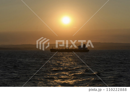 Cargo vessel at sea. Bulk carrier. Dry cargo ship at sunset. 110222888