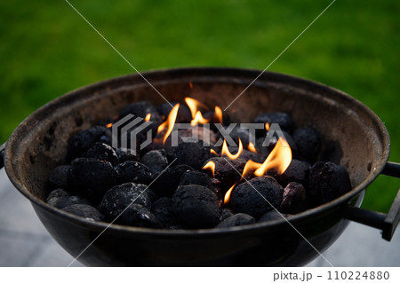 Burning coals for barbecue during a picnic Burning coals for barbecue during a picnic 110224880