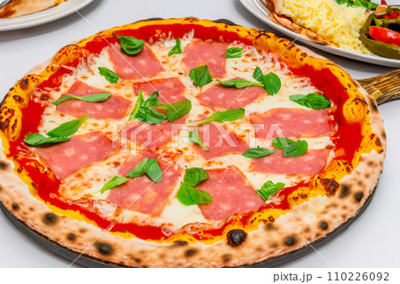 Pizza. Homemade pizza. Delicious pizza. Freshly made Italian margherita pizza with buffalo mozzarella and basil. Pizza with cheese, tomato sauce. Wood oven. World Pizza Day. February 9. 2024. 110226092