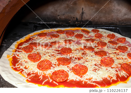 Pizza. Homemade pizza. Delicious pizza. Freshly made Italian margherita pizza with buffalo mozzarella and basil. Pizza with cheese, tomato sauce. Wood oven. World Pizza Day. February 9. 2024. 110226137