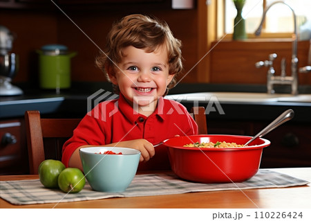 Happy Child Cooking in Kitchen, Joyful and Smiling Little Kid Helping with Meal Preparation 110226424