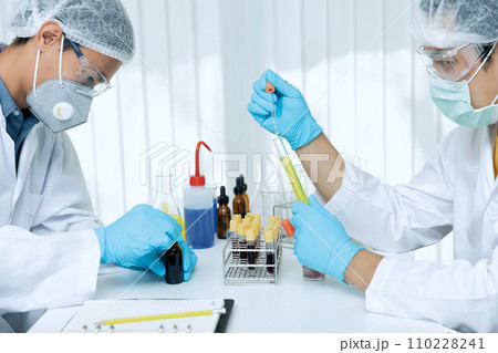 Researchers test blood samples and plasma in the laboratory. Researchers are inventing vaccines to treat COVID-19 virus. 110228241