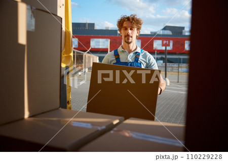 Warehouse worker loading van preparing parcel box for delivery 110229228