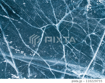 Beautiful cracks surface of the frozen lake of Baikal lake with frost methane bubbles in winter season. Beautiful cracks surface of the frozen lake of Baikal lake with frost methane bubbles in winter season. 110229735