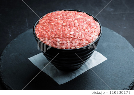Minced meat inside dark bowl Minced meat inside dark bowl 110230175