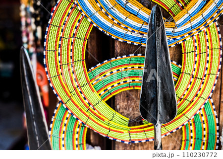 Masai colorful decorations and spear at market 110230772
