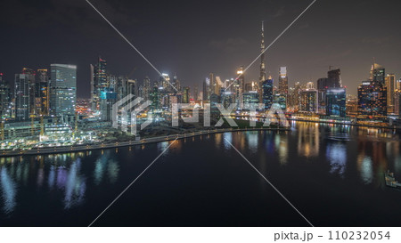 Panorama showing aerial view to Dubai Business Bay and Downtown with the various skyscrapers and towers night timelapse Panorama showing aerial view to Dubai Business Bay and Downtown with the various skyscrapers and towers night timelapse 110232054