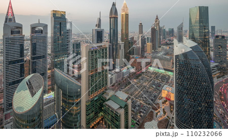 Skyline view of the high-rise buildings on Sheikh Zayed Road in Dubai aerial day to night timelapse, UAE. Skyline view of the high-rise buildings on Sheikh Zayed Road in Dubai aerial day to night timelapse, UAE. 110232066