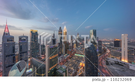 Skyline view of the high-rise buildings on Sheikh Zayed Road in Dubai aerial day to night timelapse, UAE. 110232069