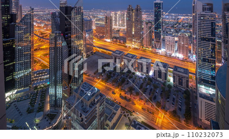 High-rise buildings on Sheikh Zayed Road in Dubai aerial night to day timelapse, UAE. High-rise buildings on Sheikh Zayed Road in Dubai aerial night to day timelapse, UAE. 110232073