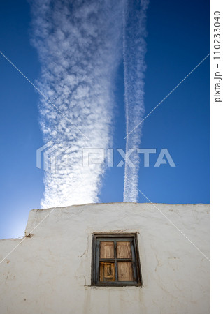 Typical white archtecture and blue sky with chemtrails Typical white archtecture and blue sky with chemtrails 110233040