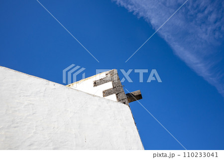 Typical white archtecture and blue sky with chemtrails 110233041