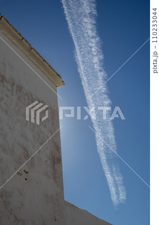 Typical white archtecture and blue sky with chemtrails Typical white archtecture and blue sky with chemtrails 110233044