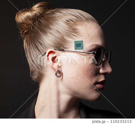 Portrait of woman's face in sunglasses with CPU processor microchip Portrait of woman's face in sunglasses with CPU processor microchip 110233213