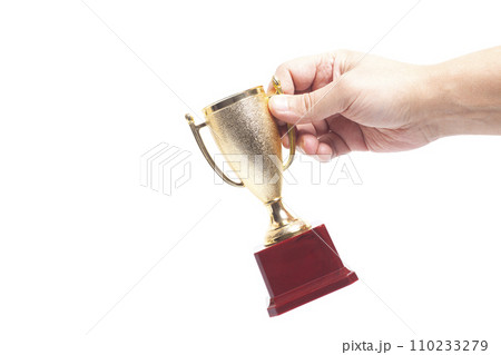 Golden trophy cup In a man's hand isolated on white background. Golden trophy cup In a man's hand isolated on white background. 110233279
