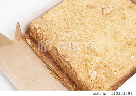 Napoleon cake in a cardboard box. Top view. Napoleon cake in a cardboard box. Top view. 110233592