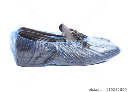 black men's leather shoes in shoe covers isolated on white background. 110233890