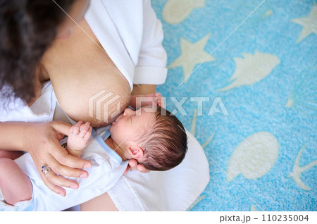 Mother breastfeeding her newborn baby. Mother breast milk is the best medicine for kids the first six months of life 110235004