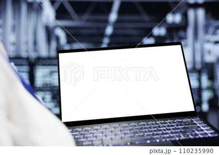 Close up shot of mock up laptop used by adept IT admin in data center delivering massive computing power, capable of processing and storing vast amounts of datasets and controlling network resources 110235990