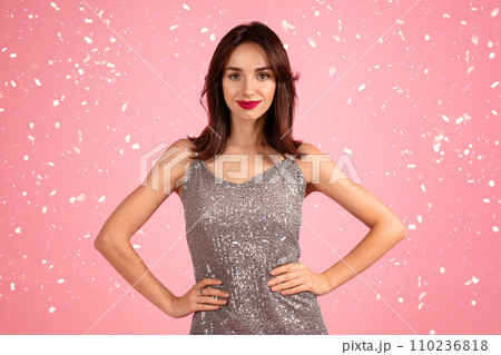 Cheerful confident millennial caucasian brunette woman in dress enjoy confetti on party Cheerful confident millennial caucasian brunette woman in dress enjoy confetti on party 110236818