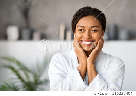 Beautiful Black Young Woman Wearing White Bathrobe Standing In Stylish Bathroom Interior Beautiful Black Young Woman Wearing White Bathrobe Standing In Stylish Bathroom Interior 110237404