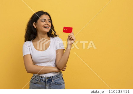 Positive young indian lady with credit card in her hand 110238411