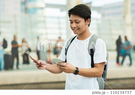 Portrait Of Asian Man Using Smartphone While Waiting At Airport 110238737