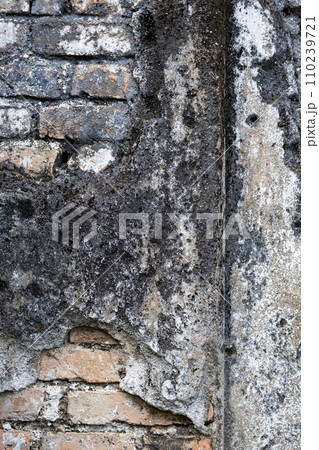 Detail of eroded building wall. Ancient damaged wall. 110239721