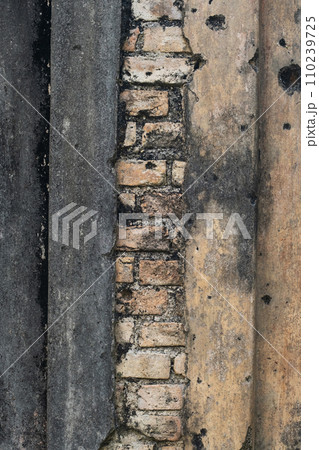 Ancient damaged brick wall surface. 110239725