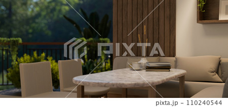 A modern, luxury dining room with a marble table, chairs, cosy corner couch, and a balcony. A modern, luxury dining room with a marble table, chairs, cosy corner couch, and a balcony. 110240544