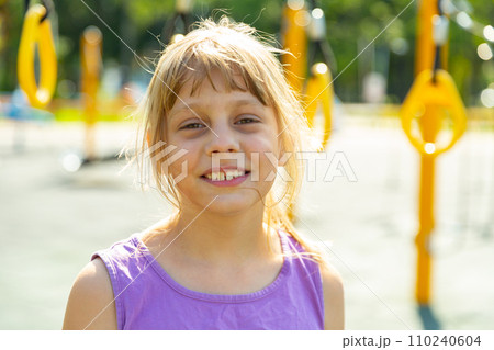 Portrait of a positive nine year old teenage girl on a playground Portrait of a positive nine year old teenage girl on a playground 110240604