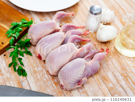 Fresh raw meat quails ready for cooking on slate board 110240631