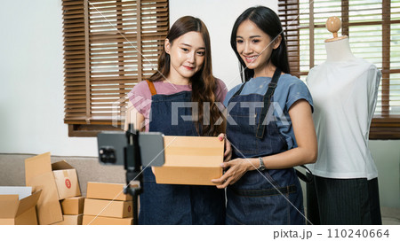 Beautiful asian woman showing clothes for sale in front of camera for live streaming at home 110240664