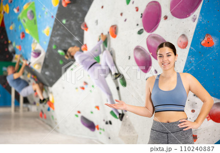 Young woman posing on climbing wall Young woman posing on climbing wall 110240887