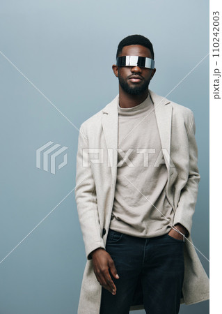 Cheerful african man wearing glasses jean jacket having white snow smile pointing fingers aside at copy space for your text advertisement, advertise teeth whitening or eyewear store good offer concept 110242003
