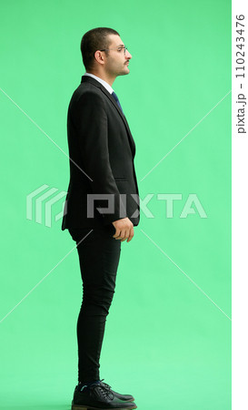 young man in full growth. isolated on green background profile 110243476
