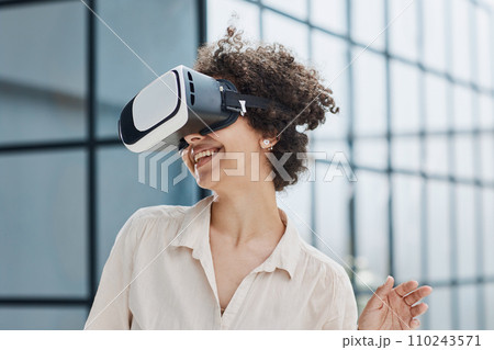 a girl in a modern office uses 3D glasses to study a new project 110243571