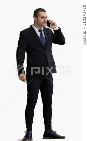 man in full growth. isolated on white background using phone 110243710