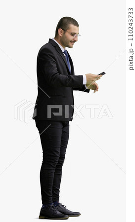 young man in full growth. isolated on white background taking selfie 110243733