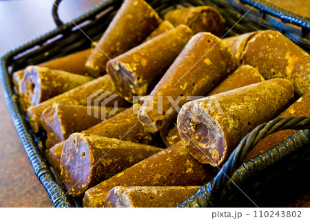 Traditional Palm Sugar in Rustic Basket, Elevated Perspective Close-Up Traditional Palm Sugar in Rustic Basket, Elevated Perspective Close-Up 110243802