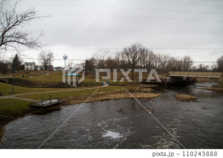 Tranquil River Park with Wooden Dock and Footbridge in Town Ann Arbor, Michigan Tranquil River Park with Wooden Dock and Footbridge in Town Ann Arbor, Michigan 110243888