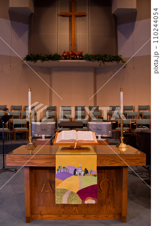 Spiritual Serenity: Pulpit View in Tranquil Church with Wooden Cross and Open Bible Spiritual Serenity: Pulpit View in Tranquil Church with Wooden Cross and Open Bible 110244054