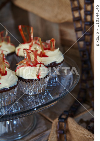 Gourmet Chocolate Cupcakes with Red Glass Candy in Rustic Setting Gourmet Chocolate Cupcakes with Red Glass Candy in Rustic Setting 110244145