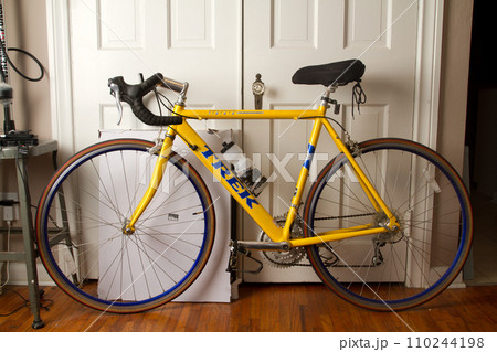 Yellow Bicycle with water bottle in Apartment Ready for a Ride 110244198