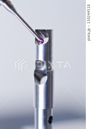 Close-up of Metrology CMM Probe Inspecting Metal Part for Minute Flaws 110244518